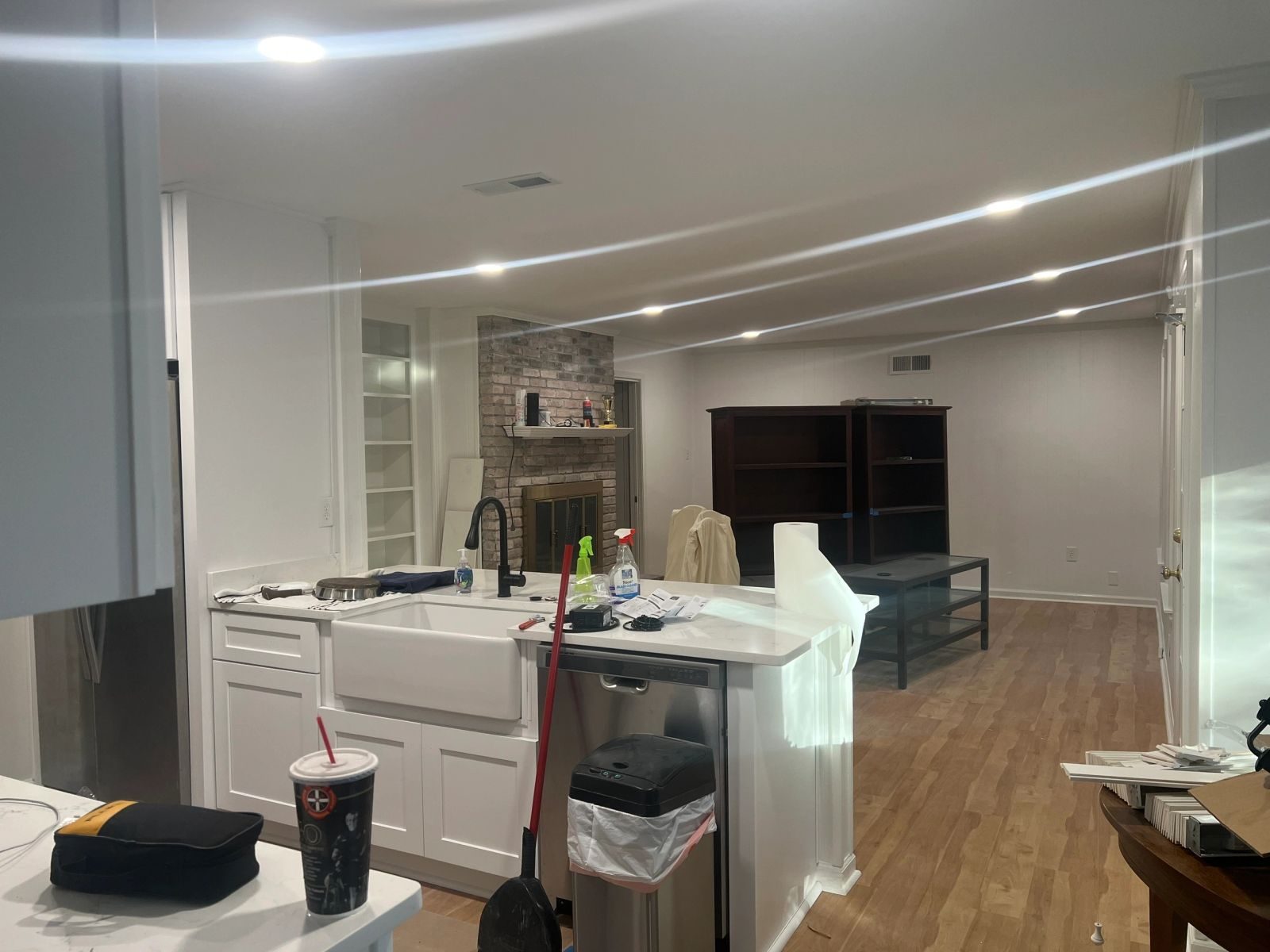 Open-plan kitchen and living room with recessed lighting