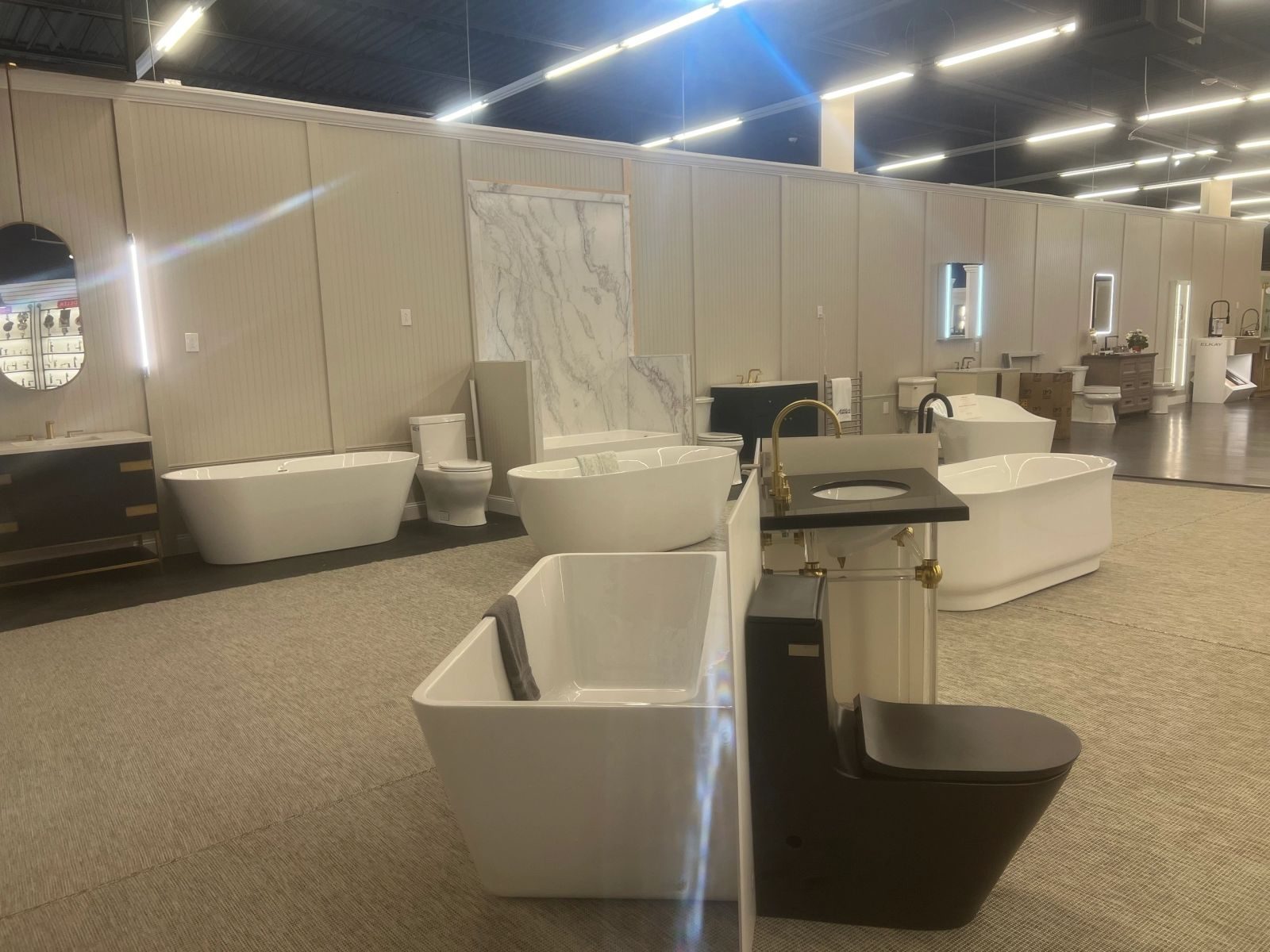 Bath showroom with linear LED ceiling lighting